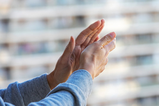 Woman Hands Applauding Medical Staff From Their Balcony. People In Spain Clapping On Balconies And Windows In Support Of Health Workers, Doctors And Nurses During The Coronavirus Pandemic