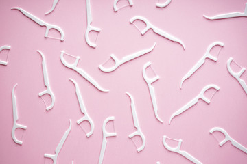 Toothpicks on a pink background, flat lay composition.