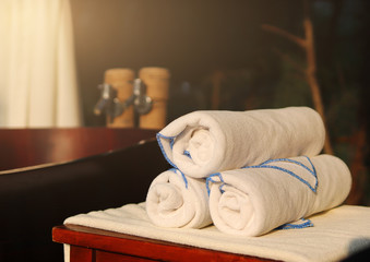 fresh towels and a wooden bathtub for Spa and massage treatments