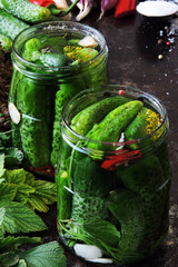 Jars with cucumbers and spices. Home cooking. The process of pickling cucumbers. Fermentation of products.