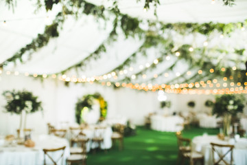 Evening wedding banquet party or night fair festival with blurred lights bokeh for background...