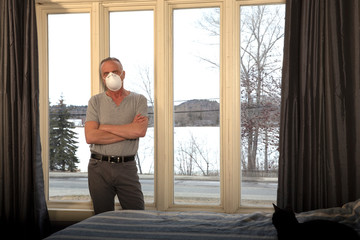 Man by window with mask on