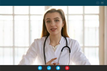 Head shot portrait female doctor wears white coat stethoscope on neck shares latest corona virus...