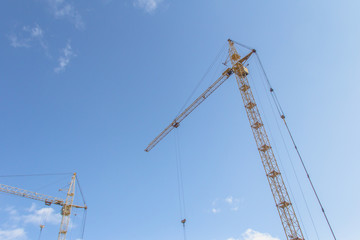 Fototapeta na wymiar Tower crane at a construction site. Lifting heavy loads