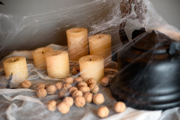 Black teapot with nuts and candles in spider halloween