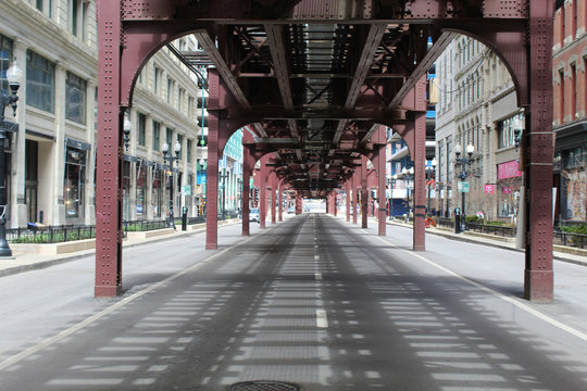 Nearly deserted Wabash Avenue in downtown Chicago under the el train tracks during the COVID-19 shelter-in-place order
