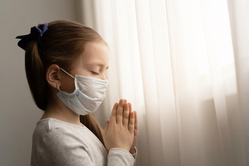 Little girl praying in the morning for a new day freedom to world corona virus.