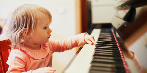 Adorable little girl playing piano © Ekaterina Pokrovsky