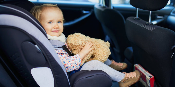 Adorable Toddler Girl In Modern Car Seat