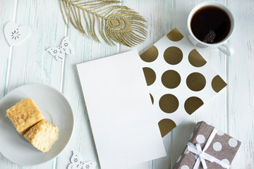 Mock up with a letter envelope, a notebook, a cup of tea, a gift box and a pen. Beauty blog concept. Flat lay, top view.