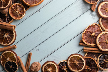 coffee beans on a wooden table in the form of a frame. Cinnamon sticks and dried fruit. Space for text. nuts on the table. boards of turquoise color.