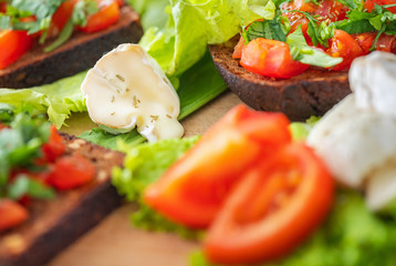 melted cheese with tomatoes and bruschetta in close up view