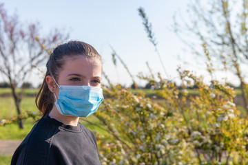 Coronavirus Covid-19 is spreading throughout Europe and Italy. Young girl before playing outdoors,...