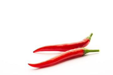 Red chili peppers on a white background. Isolate. Hot peppers. Fresh pod of red pepper.