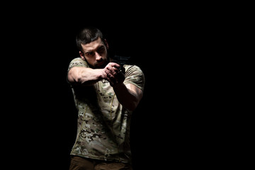 Military Man Holding Gun Isolated on Black Background