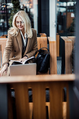 Modern elegant lady sitting in a cafe