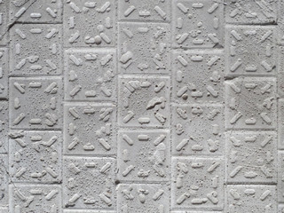 Old wall with broken ceramic tiles, background.