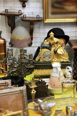 Vintage watch with sculpture of a Golden lady, hat and other items at the flea market