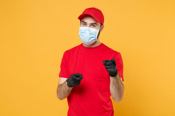 Delivery man in red cap blank t-shirt uniform sterile face mask gloves isolated on yellow...
