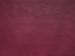 Cherry colored faux leather surface texture, background.