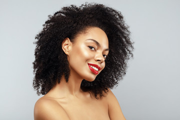 African American Fashion Model portrait. Brunette curly haired young woman. Beauty salon and haircare concept.