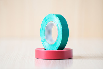 Red and green insulating tapes to insulate the twist of electrical wires.
