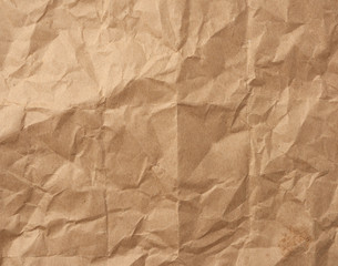 fragment of crumpled blank sheet of brown wrapping kraft paper