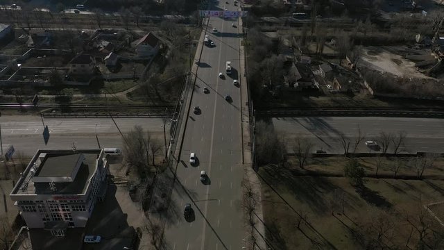 Aerial drone view flight over the Buildings, Grigore Vieru street. Cars on a bridge passing a river BIC. Winter day in Kishinev 2020