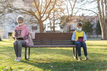 Grandmother and grandson separated by social distancing