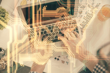 Double exposure of man's hands typing over computer keyboard and tech theme hologram drawing. Top view. Technology concept.
