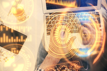 Double exposure of man's hands typing over computer keyboard and tech theme hologram drawing. Top...