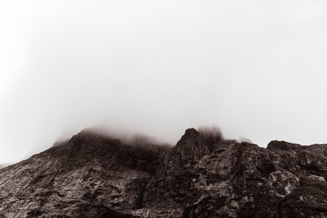 tall rocky cliffs covered in fog