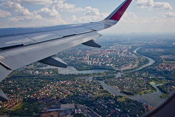 Fototapeta premium Aerial view of Moscow, Russia, from an airplane with wing traveling concept