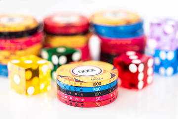 Poker chips and dice on a white background
