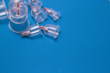Jars for hijama. Vacuum pumps on a blue background