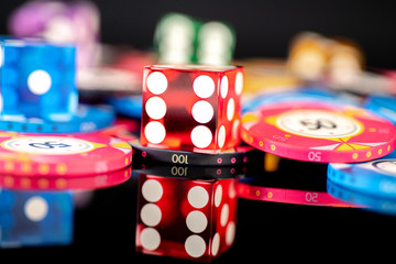 chips and dice on a black background