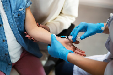 Close up of brave kid getting injection in hospital