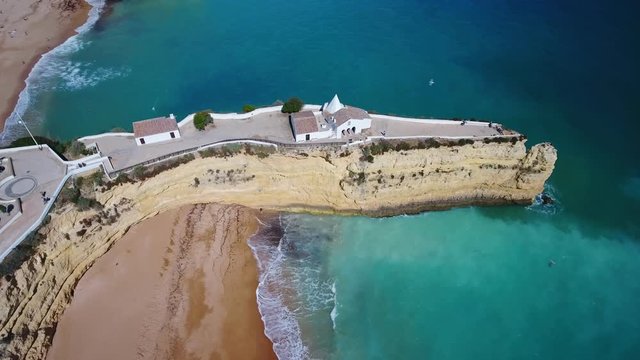 Aerial. Portuguese beach Senhora da Rocha, church on the cape, aerial view. Armacao de Pera Algarve