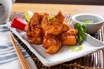 A view of an appetizer plate of Japanese chicken karaage, in a restaurant or kitchen setting.