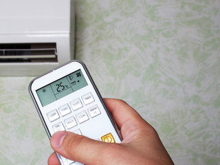 remote controllerair conditioner in hand