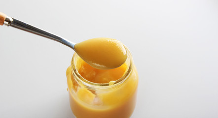 puree baby in a glass on a light background