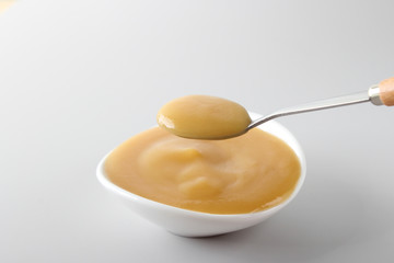puree baby in a glass on a light background