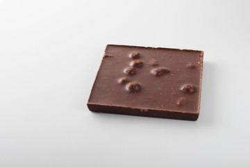 chocolate bar with hazelnut on a light background