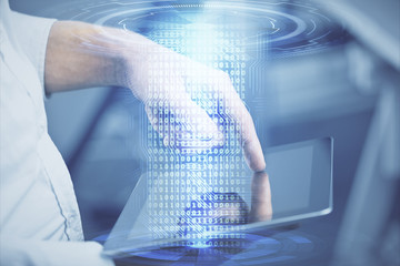 Double exposure of man's hand holding and using a digital device and data theme hologram drawing. Technology concept.