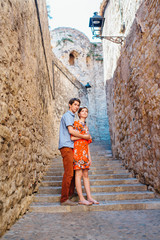 a couple in love walks through Girona Spain