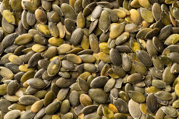 Macro background texture of green pumpkin seeds