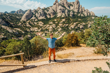 Fototapeta na wymiar A male traveller enjoys views from the mountains of Montserrat in Spain.