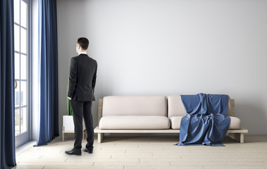 Businessman standing in living room