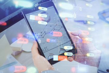 Multi exposure of man's hands holding and using a digital device and data theme drawing. Innovation concept.