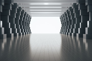 Bright concrete tunnel interior with black columns.